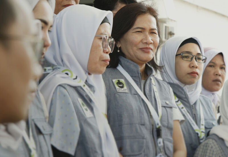 A group of workers at PT Tainan wearing vests embroidered with the Fair Trade Certified logo.