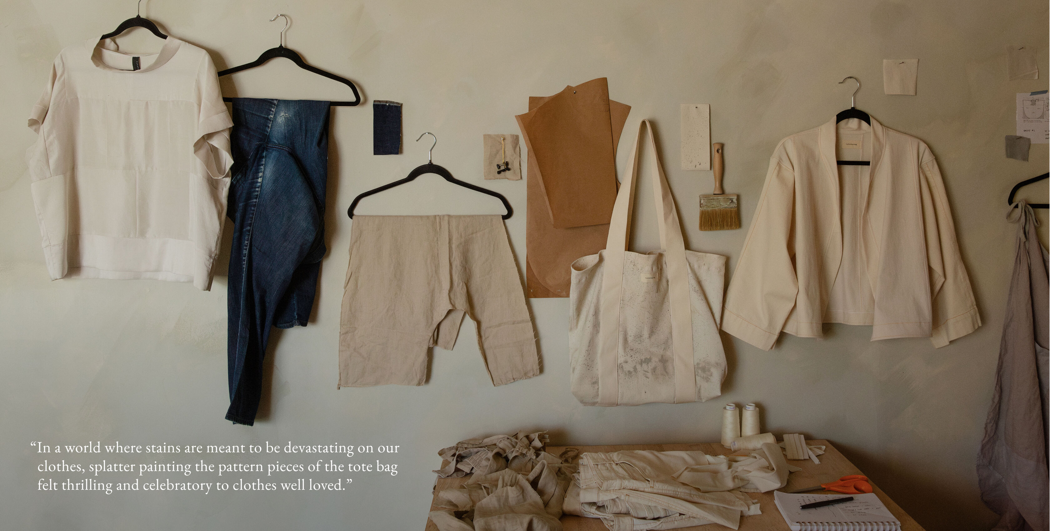 The finished pieces included a silk top, white denim jacket, and splatter paint tote hang on the wall of Elijah's store.