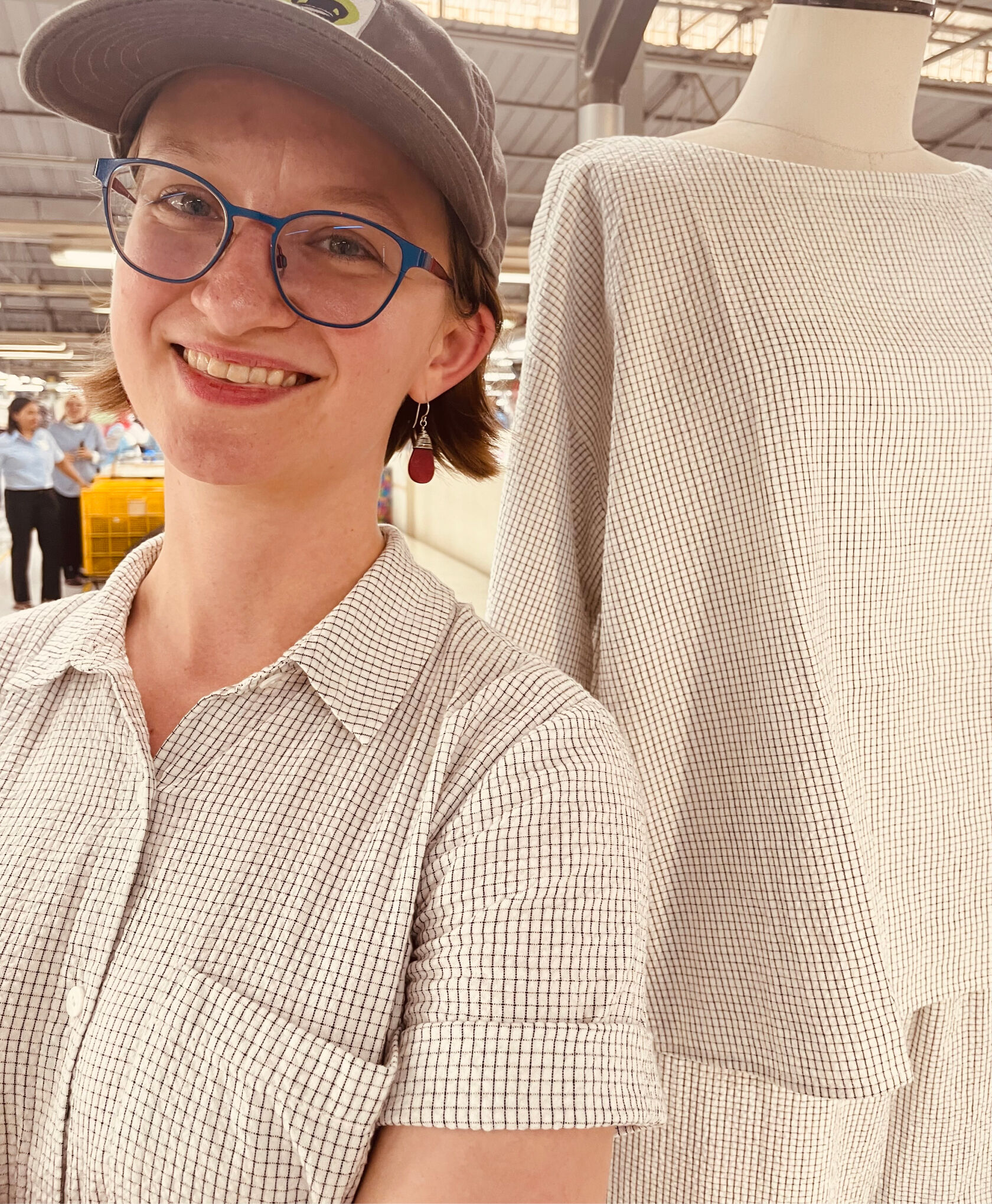 Woman wearing a puckery cotton fabric at the factory where it's being produced.
