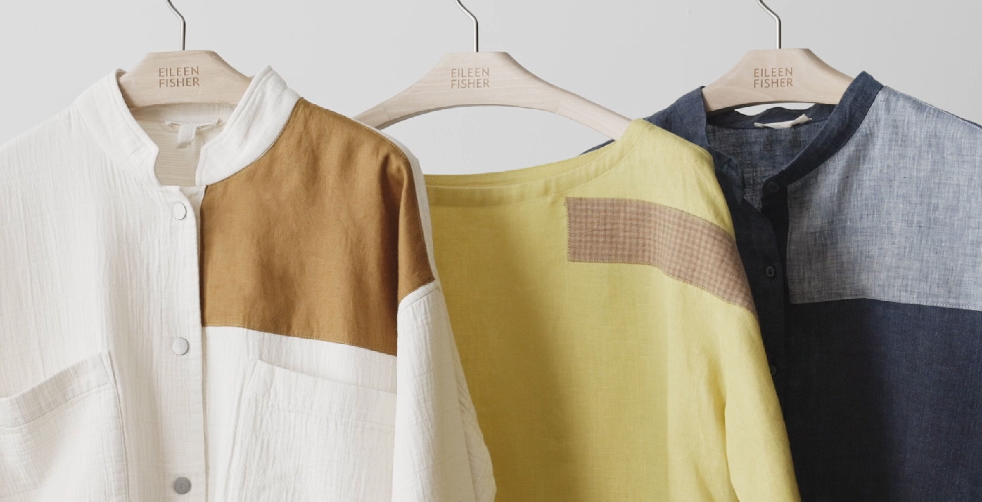 Colorful, visibly patched clothing on a rack