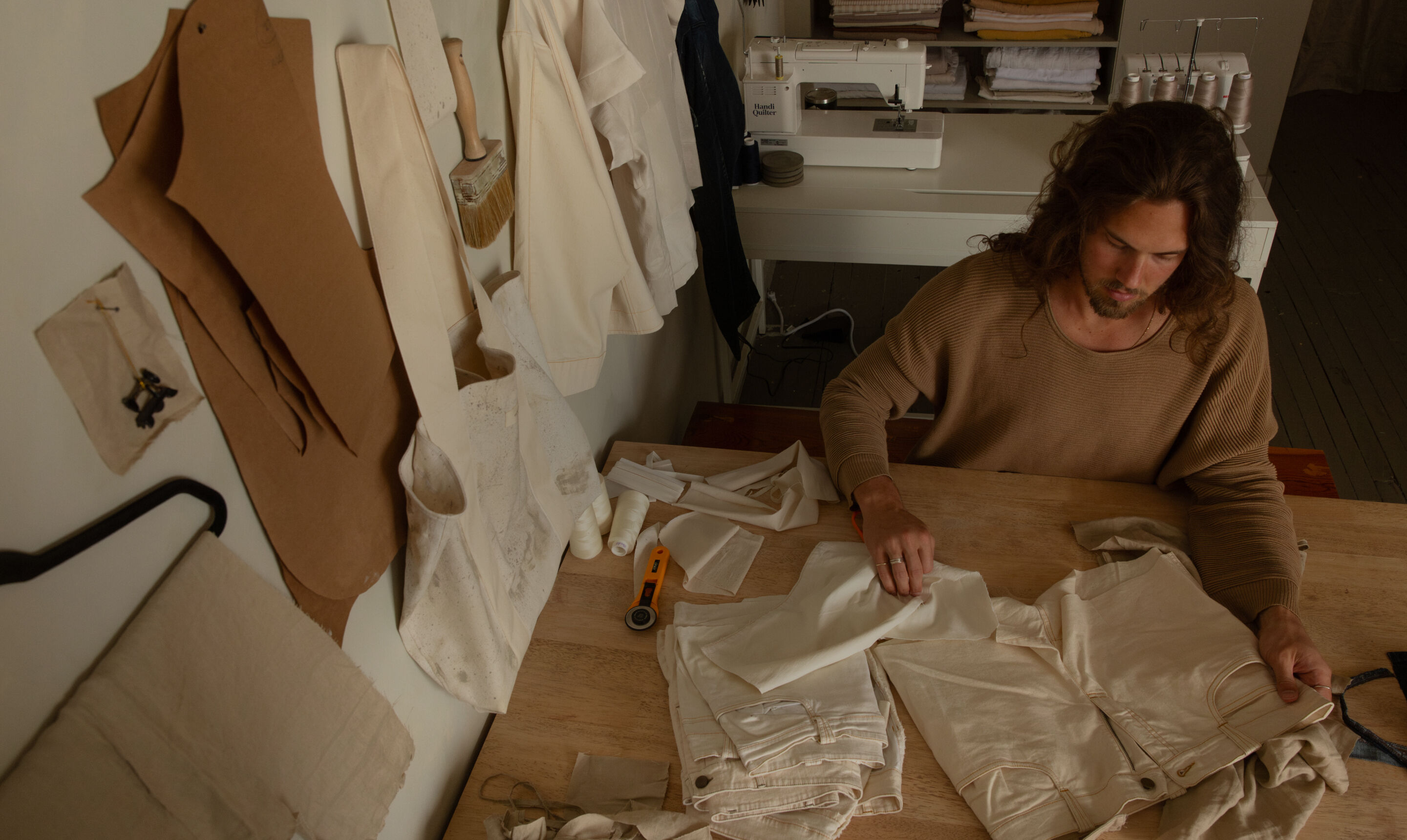 Man working on upcycled textiles in his studio.