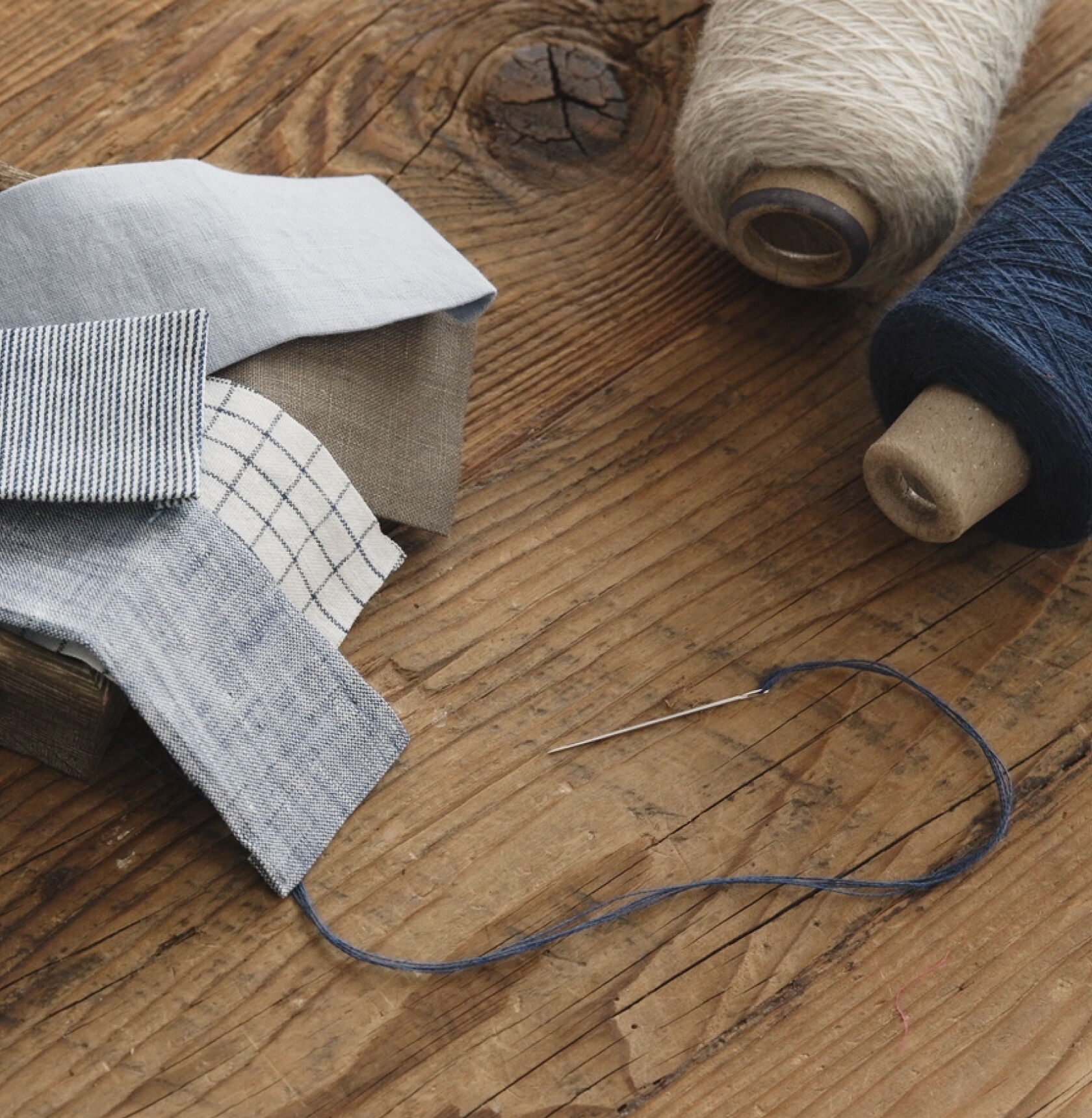 Thread, fabric patches, needle, and thread. 